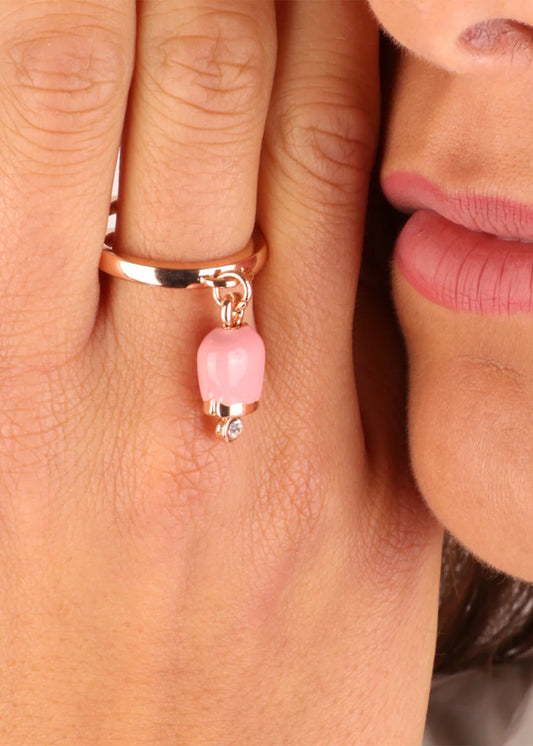 Gold-colored metal ring with pink pendant lucky bell and light point