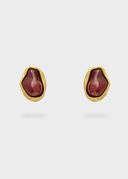 Orecchini in acciaio sinuosi con pietra bordeaux