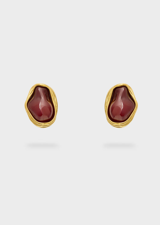 Orecchini in acciaio sinuosi con pietra bordeaux