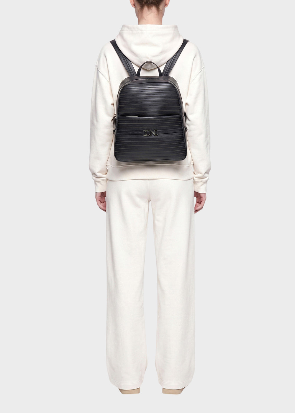 Zaino a righe con zip frontale e logo metallico